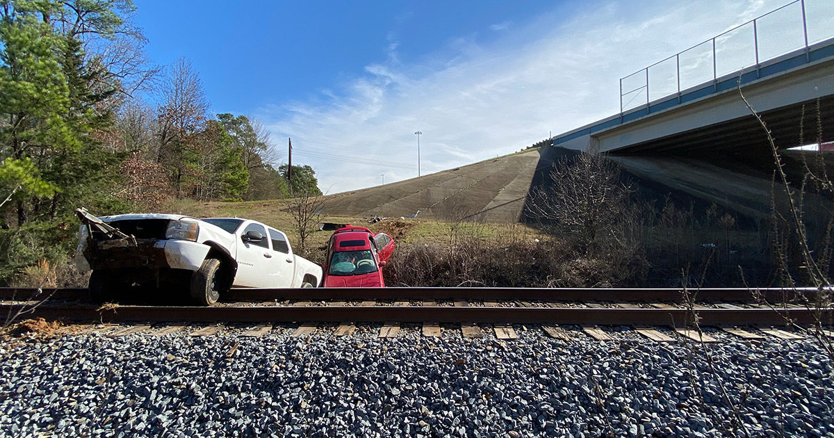 Two towed vehicles crash into railroad tracks after tow ball breaks