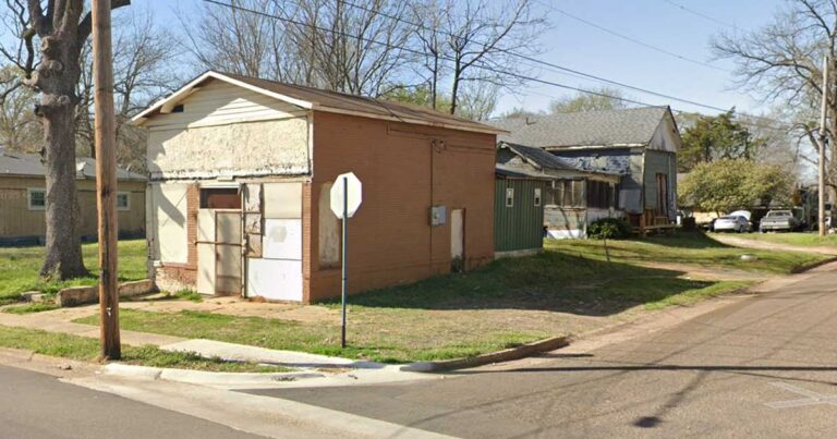 photo of an old store on the corner of two streets.