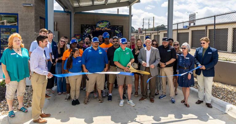 Photo of Rocket Fast carwash cutting the ribbon on their grand opening celebration