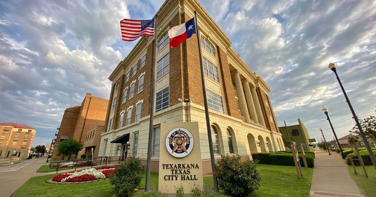 Texarkana Texas City Hall building exterior with the US and Texas flags flying out front.
