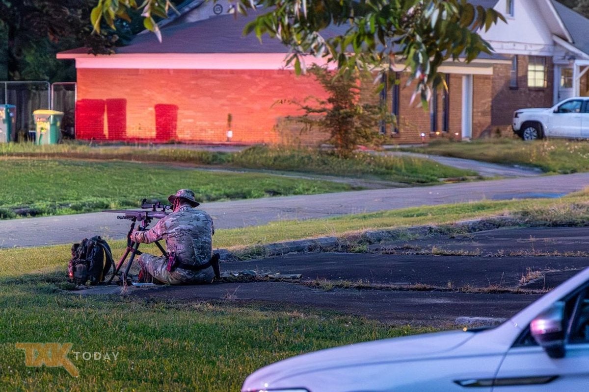 A tactical officer staged during a SWAT response near Pine Street and 13th Street.