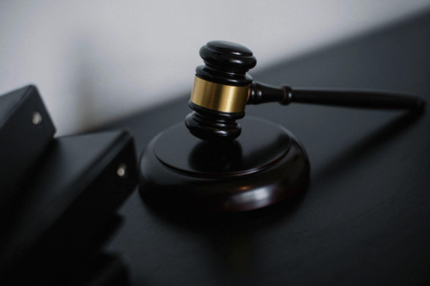A gavel on a dark desk