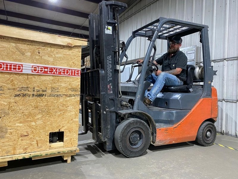 A UAHT student operates a forklift during forklift operator training