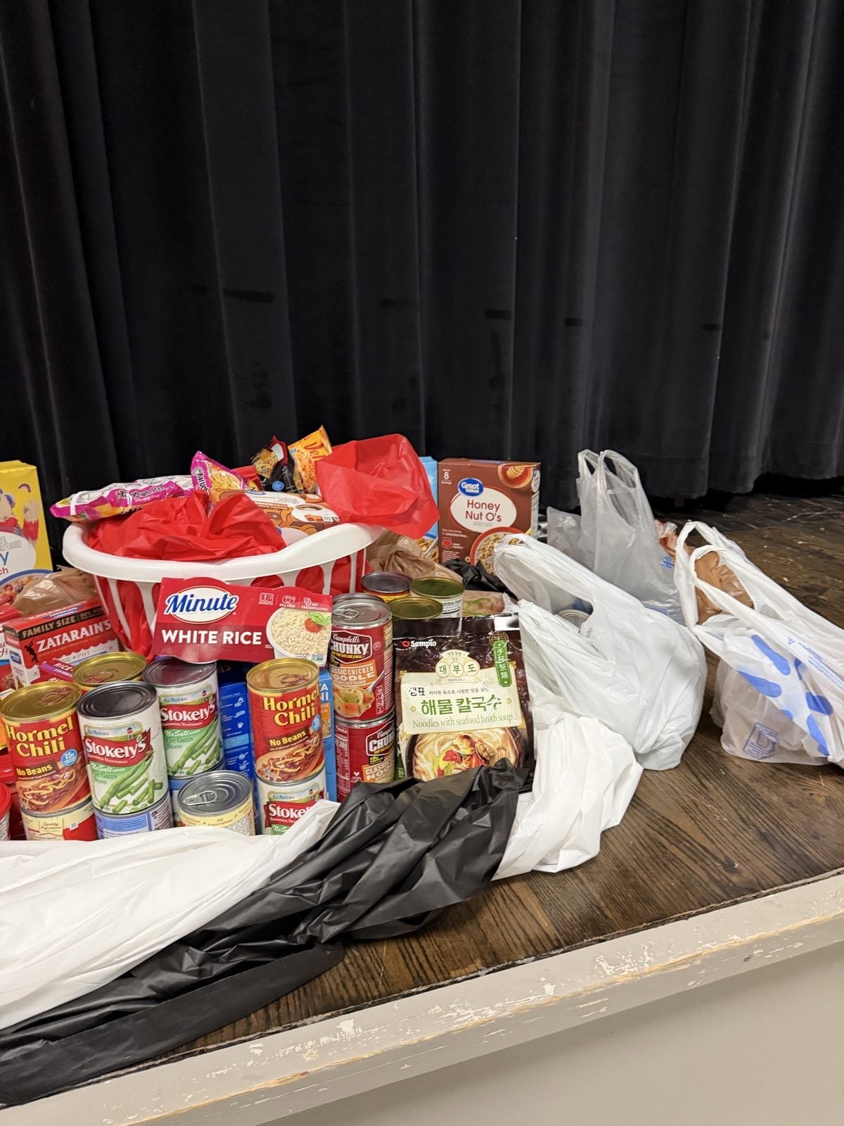 A basket and bags of donated food on a stage at Arkansas High School. Submitted photo. A basket and bags of donated food on a stage at Arkansas High School