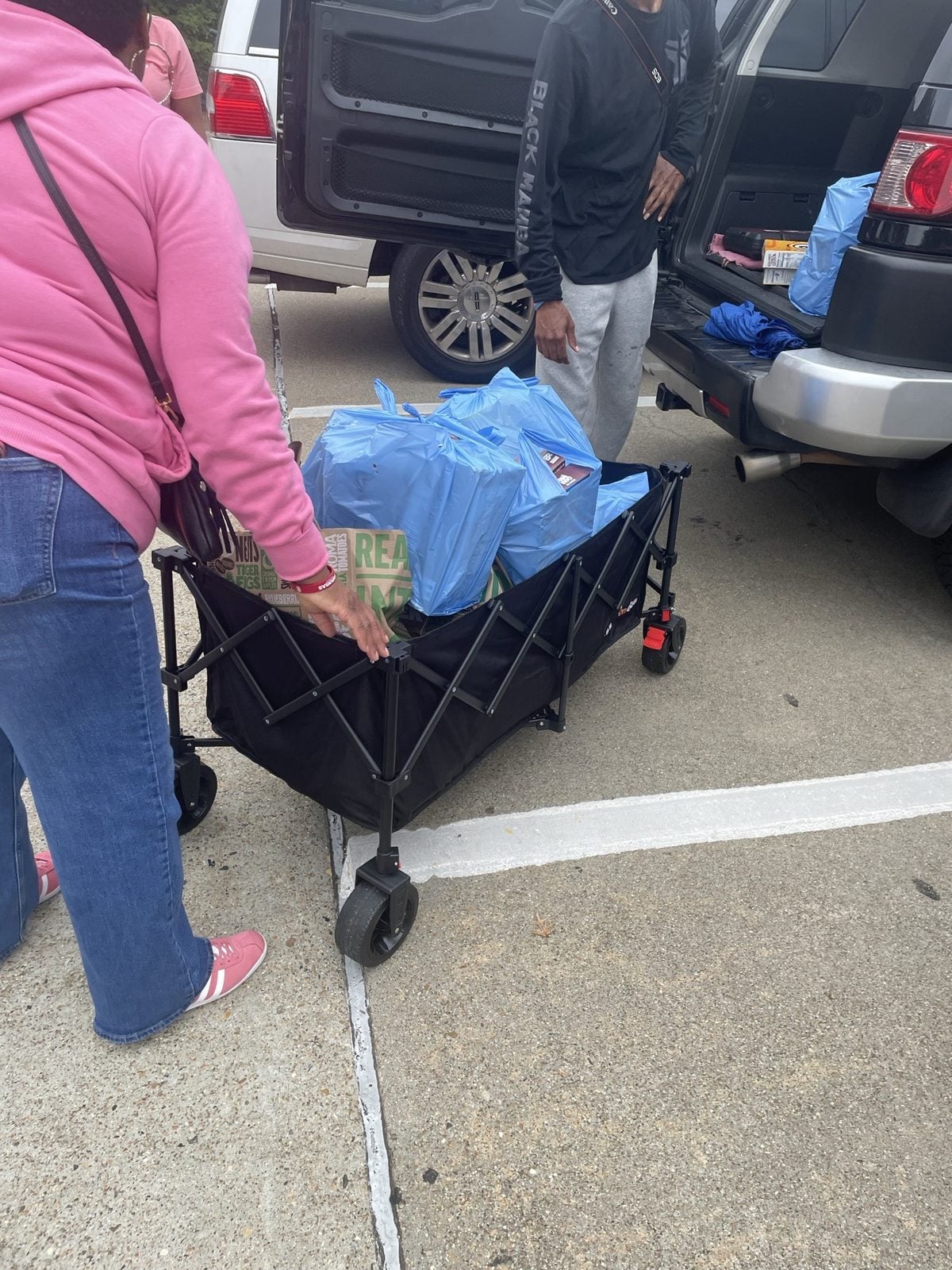 Classmates load bags of donations into a wagon from a vehicle. Submitted photo. Classmates load bags of donations into a wagon from a vehicle
