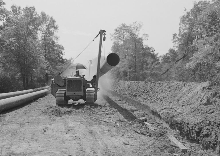 A tractor brings a 40-foot section of pipe to the main line. Photo: John Vachon, Office of War Information, Library of Congress. Tractor hauling a 40-foot section of Big Inch pipe, 1942