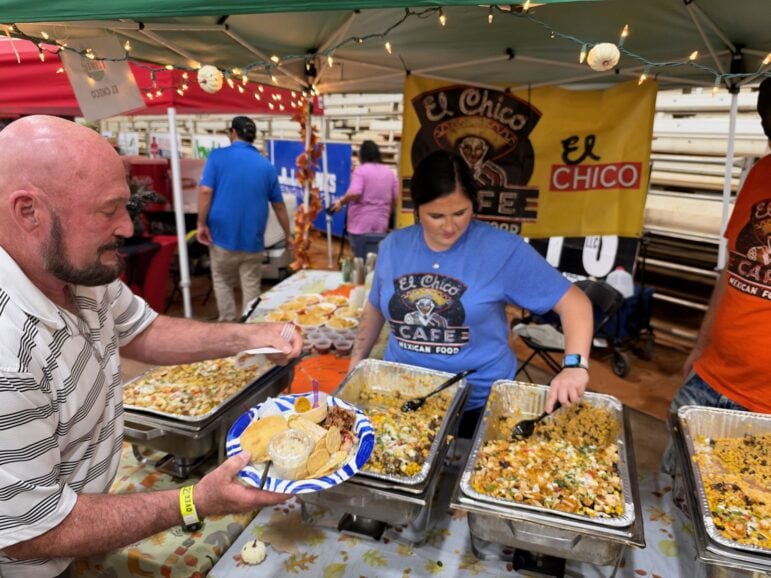 El Chico server filling a guest's plate from foil steam trays