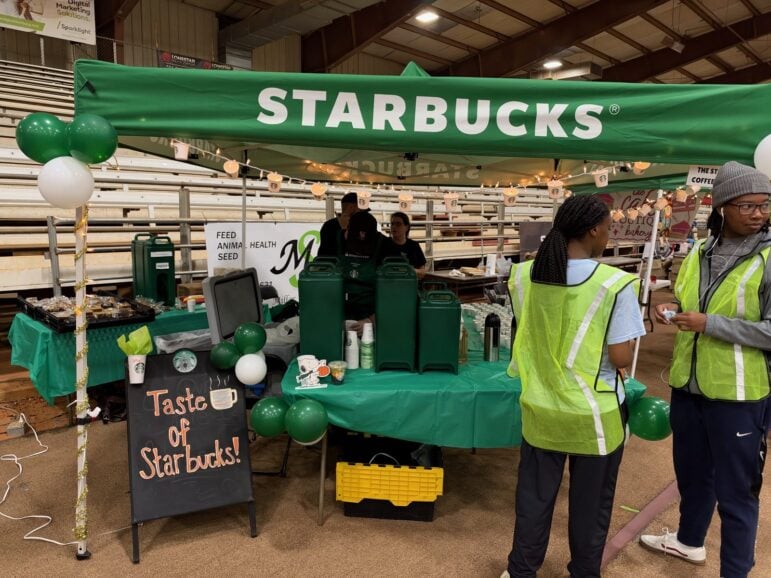 Starbucks green tent with a chalkboard sign reading Taste of Starbucks